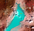 "An image from May 4, 1993, shows an interesting effect. Water from that year’s temporary lake was blown out of its bed to the north by a strong south wind. A shallow scarp, only 20–40 centimeters high, curves around the north edge of the playa and often marks the edge of the lake. But the blue color washes over the scarp in this image." (Earth Resources Observation and Science (EROS) Center)